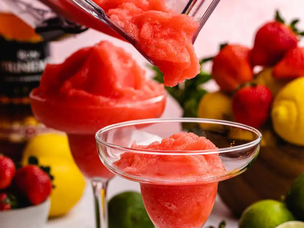Frozen and blended drink being poured into glass.