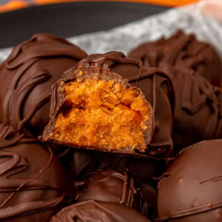 Chocolate covered candy ball with bite taken out.