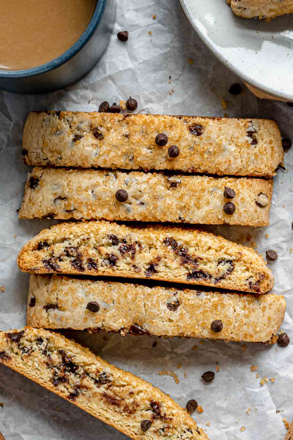 Chocolate Chip Biscotti five cookies baked and lined up in a row with bottom cookie askew