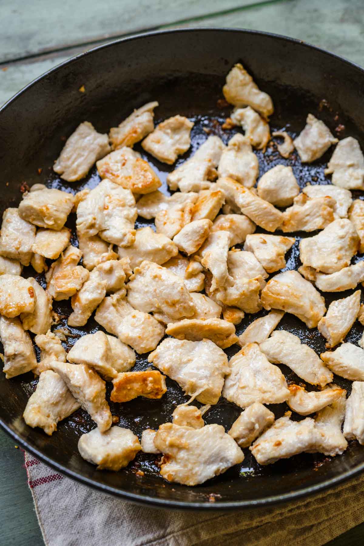 Chop Suey cooked chicken in skillet, gray blue background