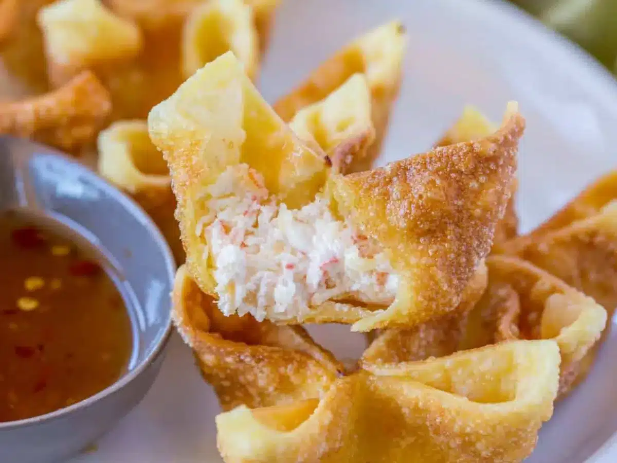 Rangoon with bite taken and dipping sauce