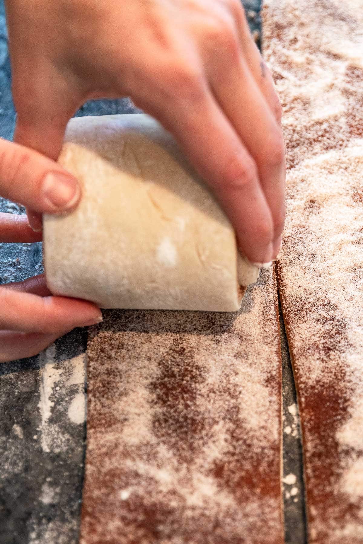Giant Cinnamon Roll dough being rolled up