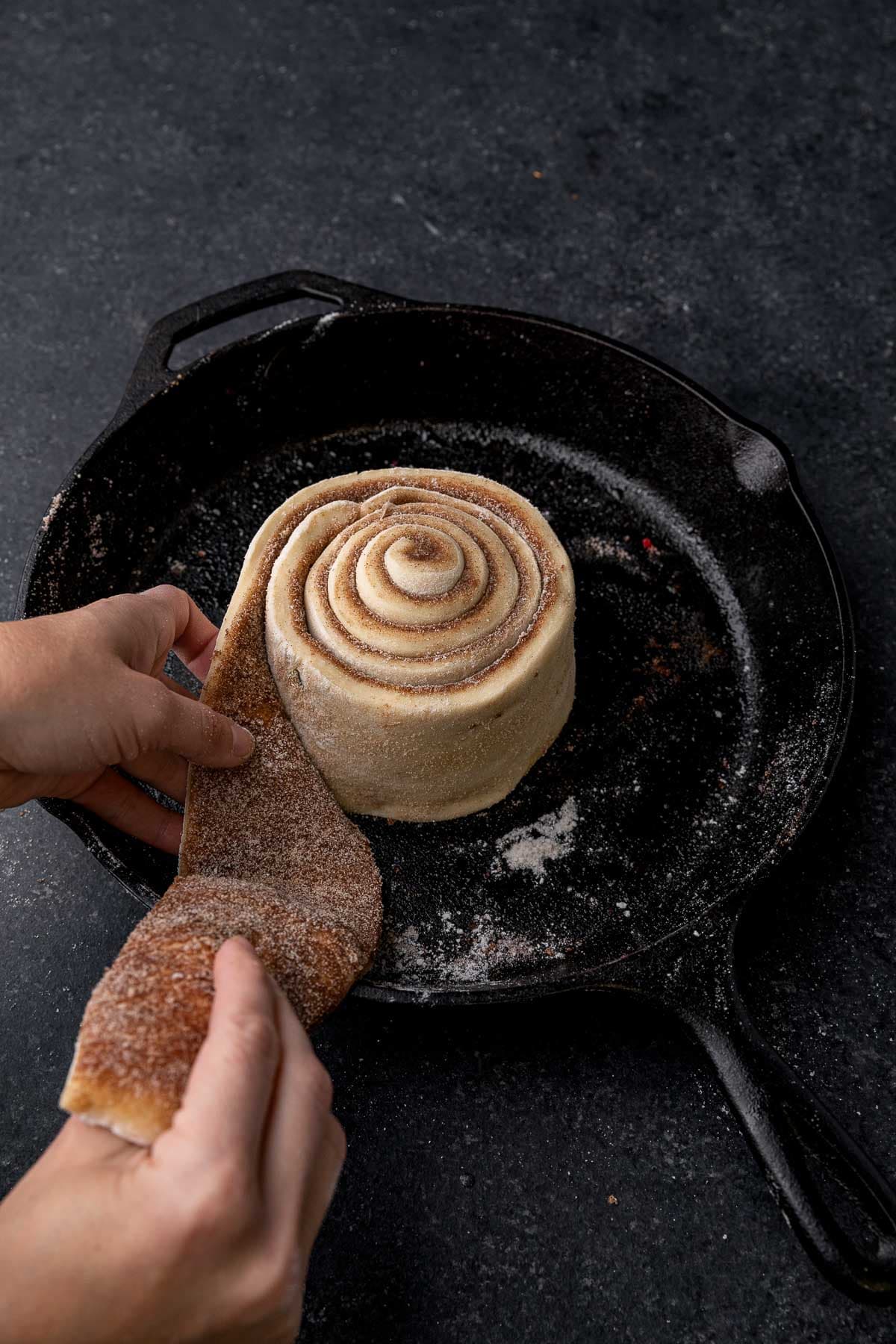 Giant Cinnamon Roll dough being rolled in skillet