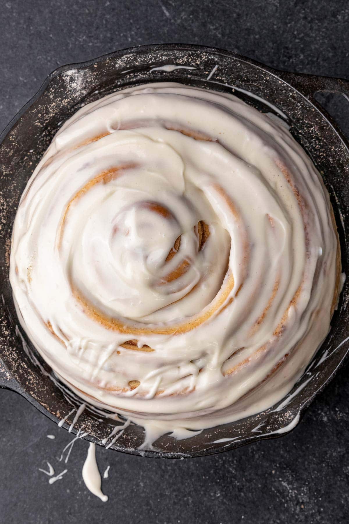 Giant Cinnamon Roll iced in skillet