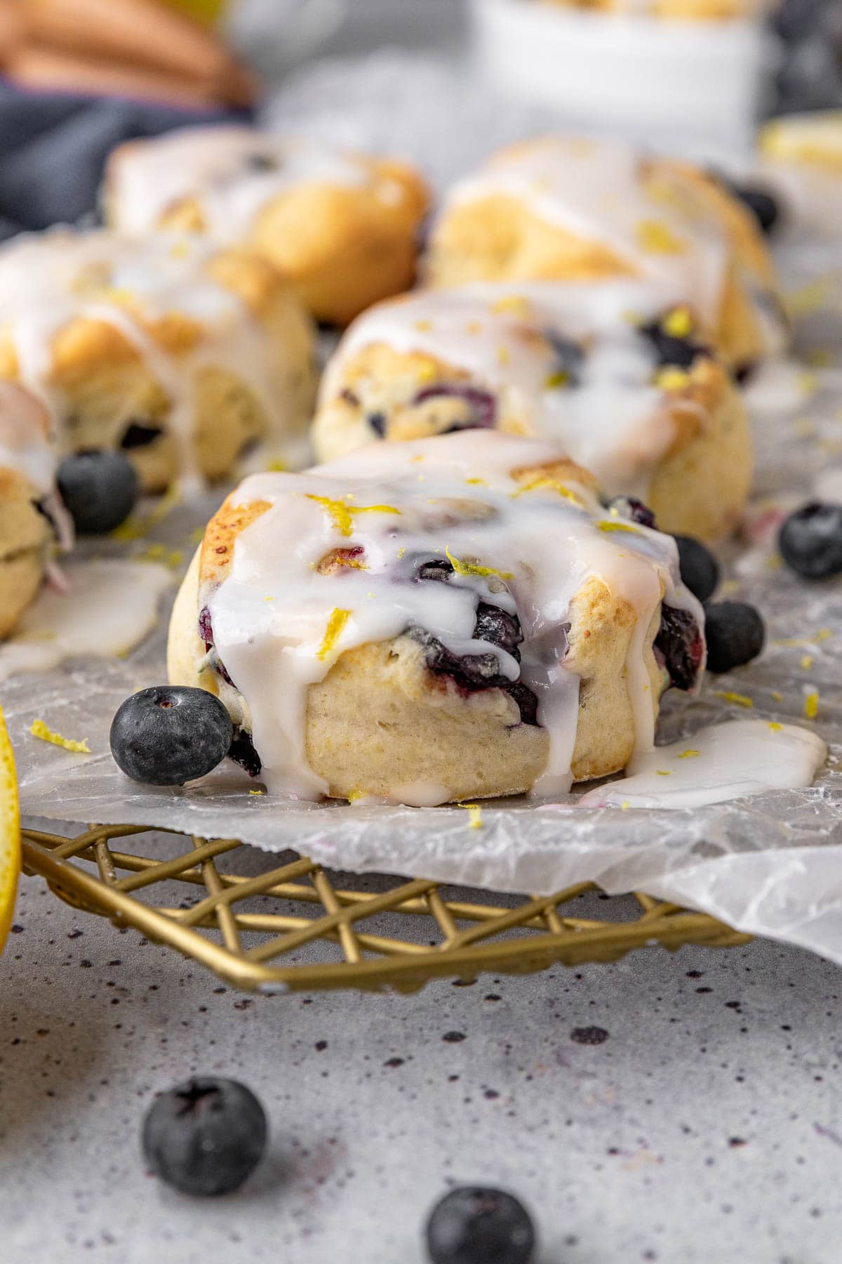 Lemon Blueberry Biscuits baked and glazed biscuits on parchment lined wire rack
