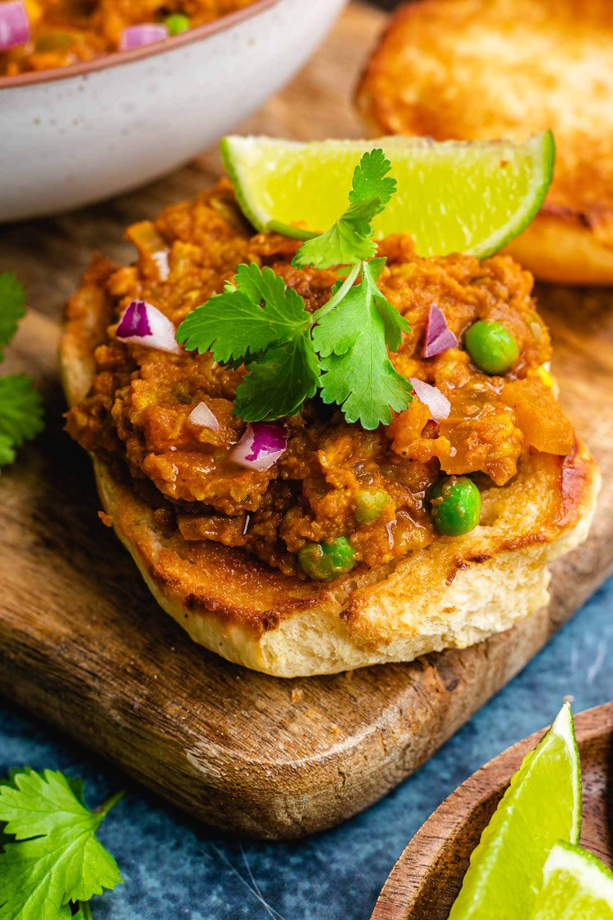 Pav Bhaji cooked and garnished on top of toasted bread