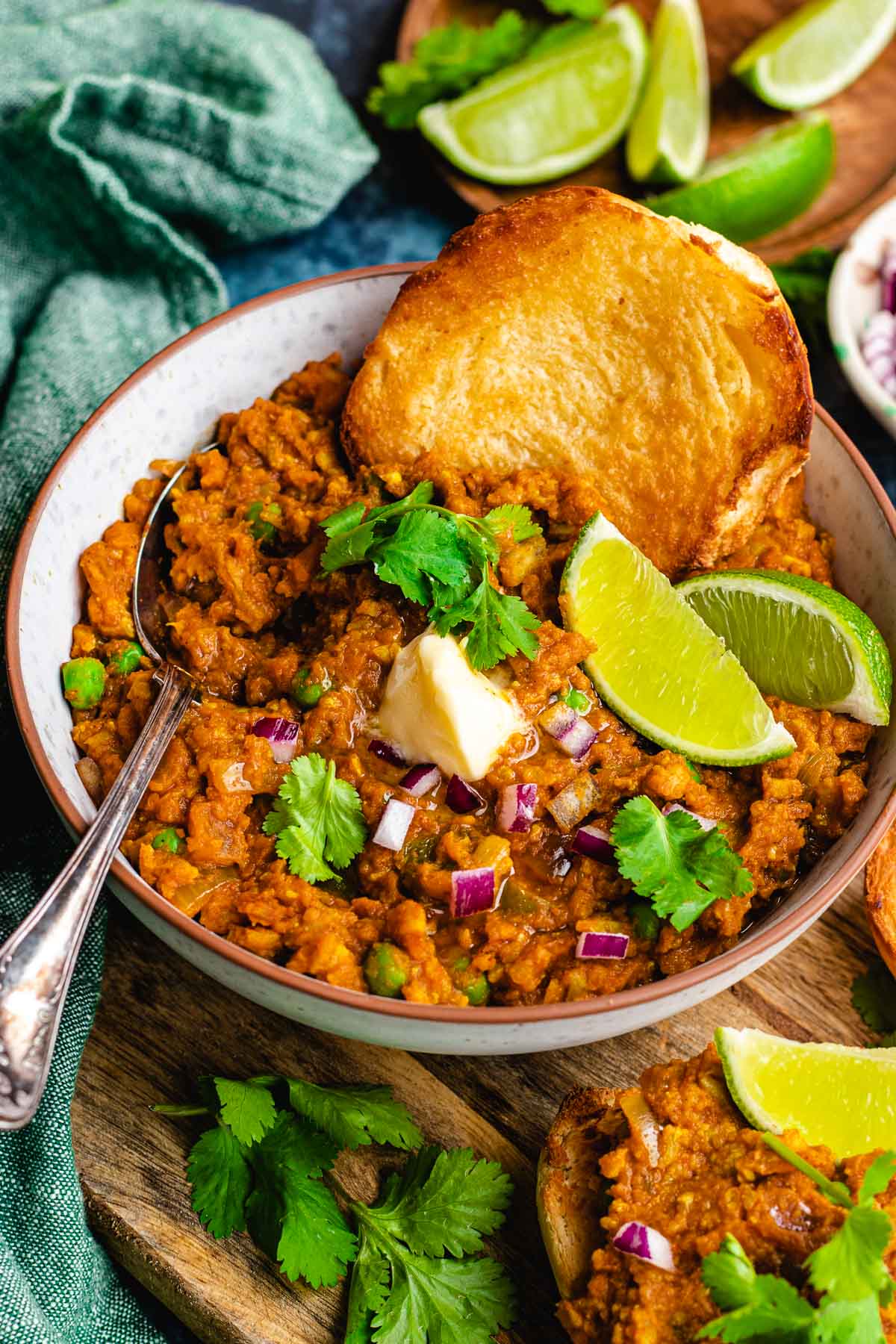 Pav Bhaji cooked and garnished in bowl with toasted bread and spoon