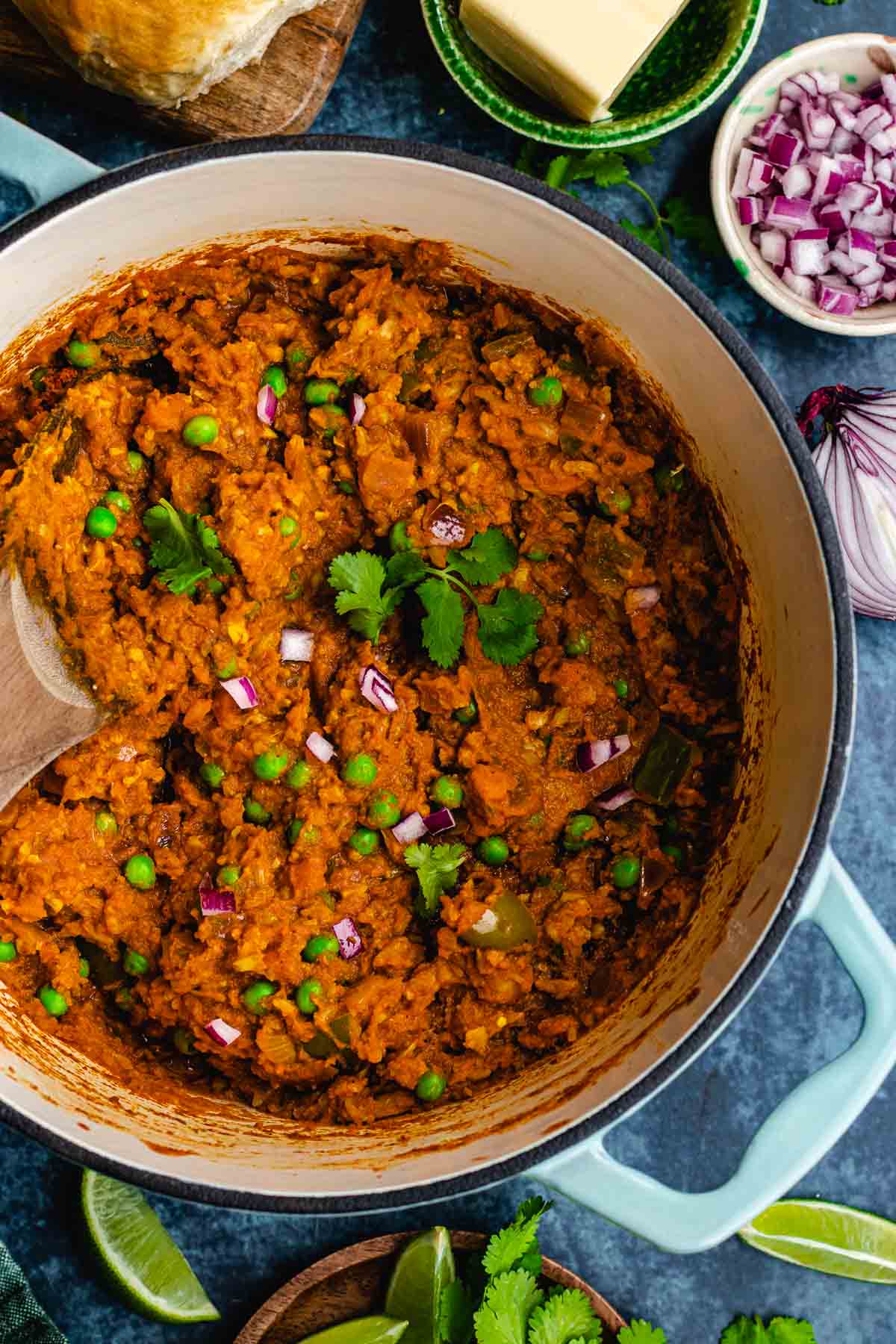 Pav Bhaji cooked in pan with some cilantro on top