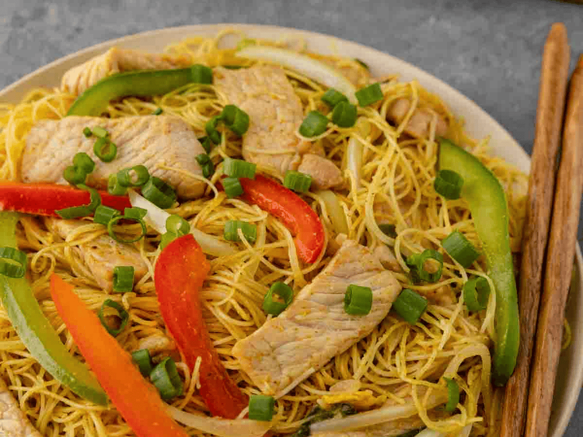 Chinese meal in bowl with chopsticks