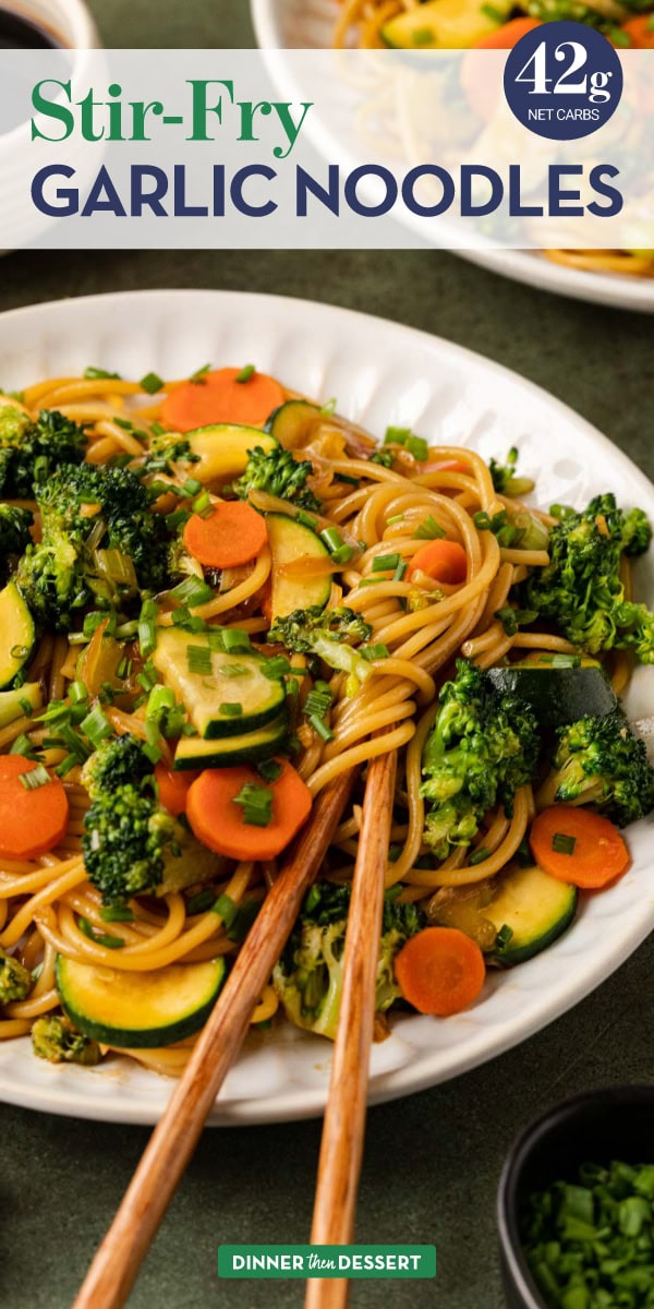 Noodles and veggies on a plate with chopsticks