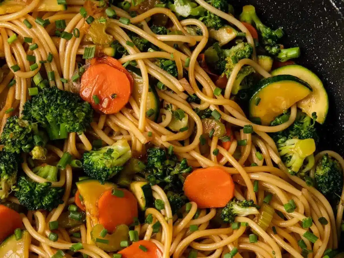 close up of noodles and veggies in wok