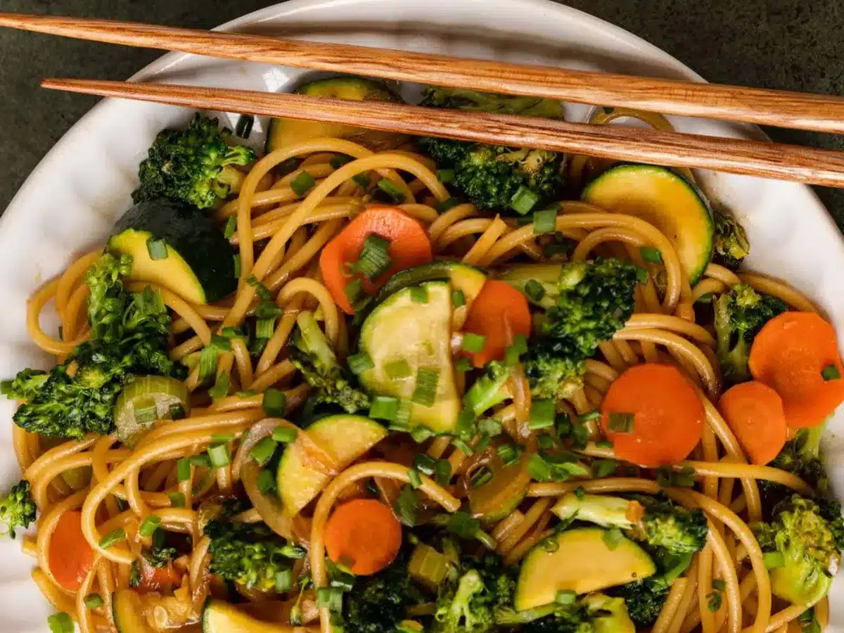 Noodles and veggie close up with chop sticks