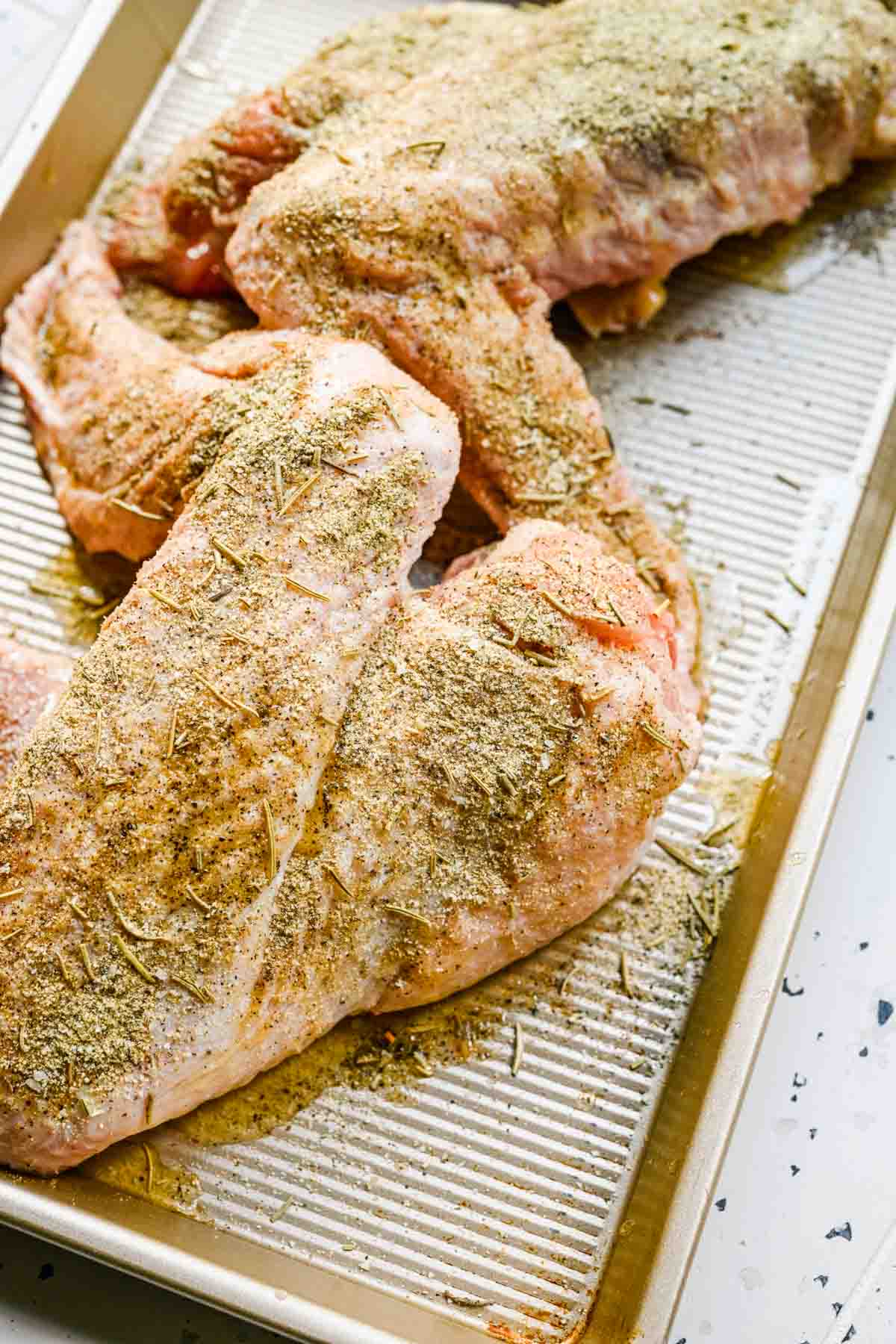 Turkey Wings uncooked wings with seasoning on baking tray