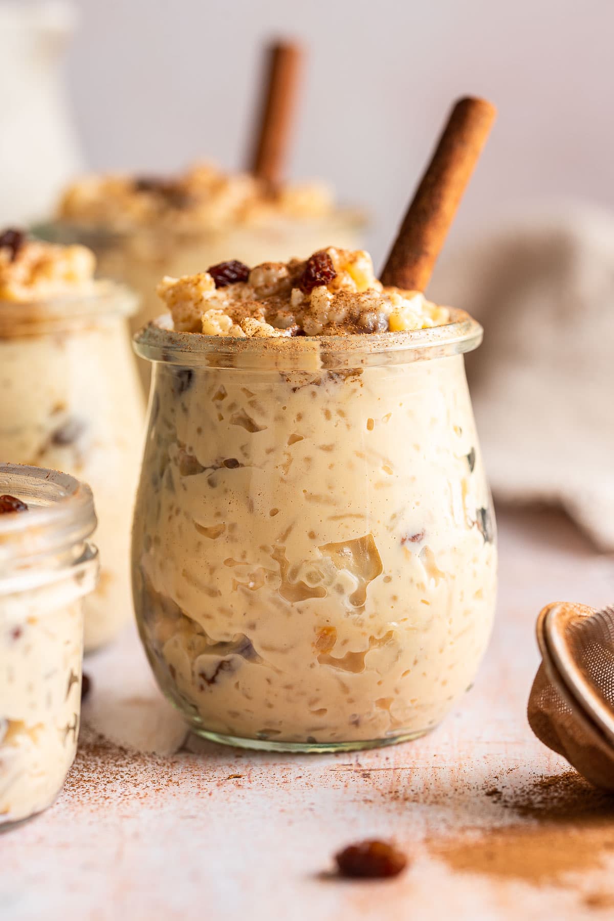 Arroz con Leche finished pudding in glass cup with cinnamon stick