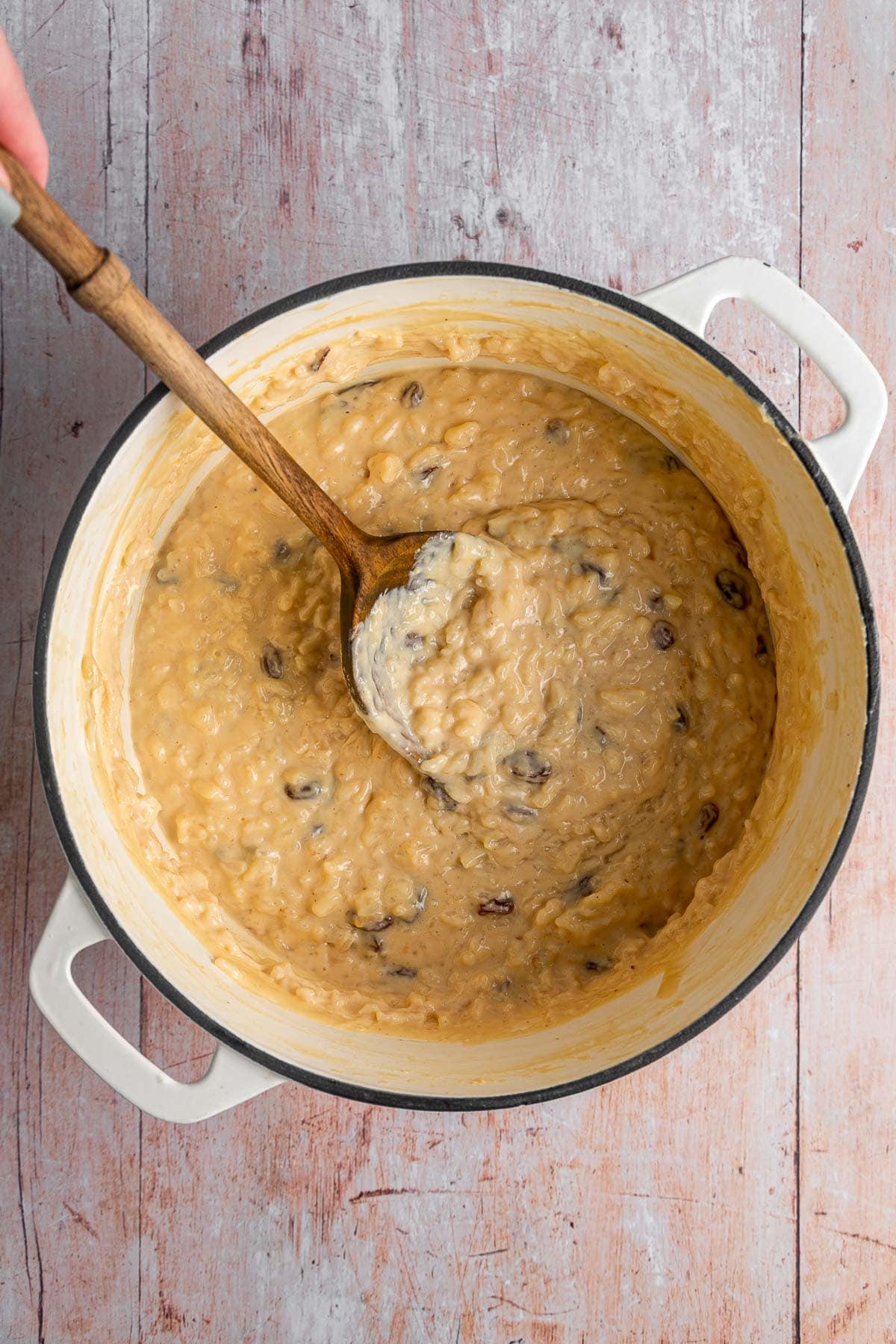 Arroz con Leche finished pudding in pan with spoon