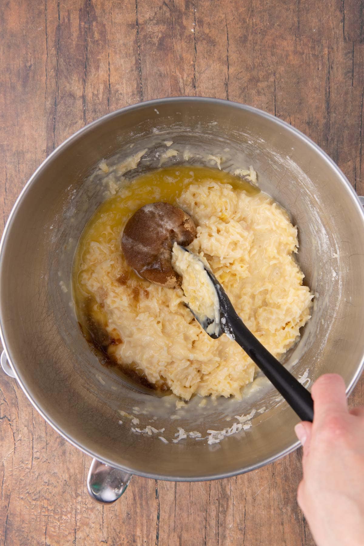 Coconut Macaroon Bars mixing vanilla into the cookie dough with spatula