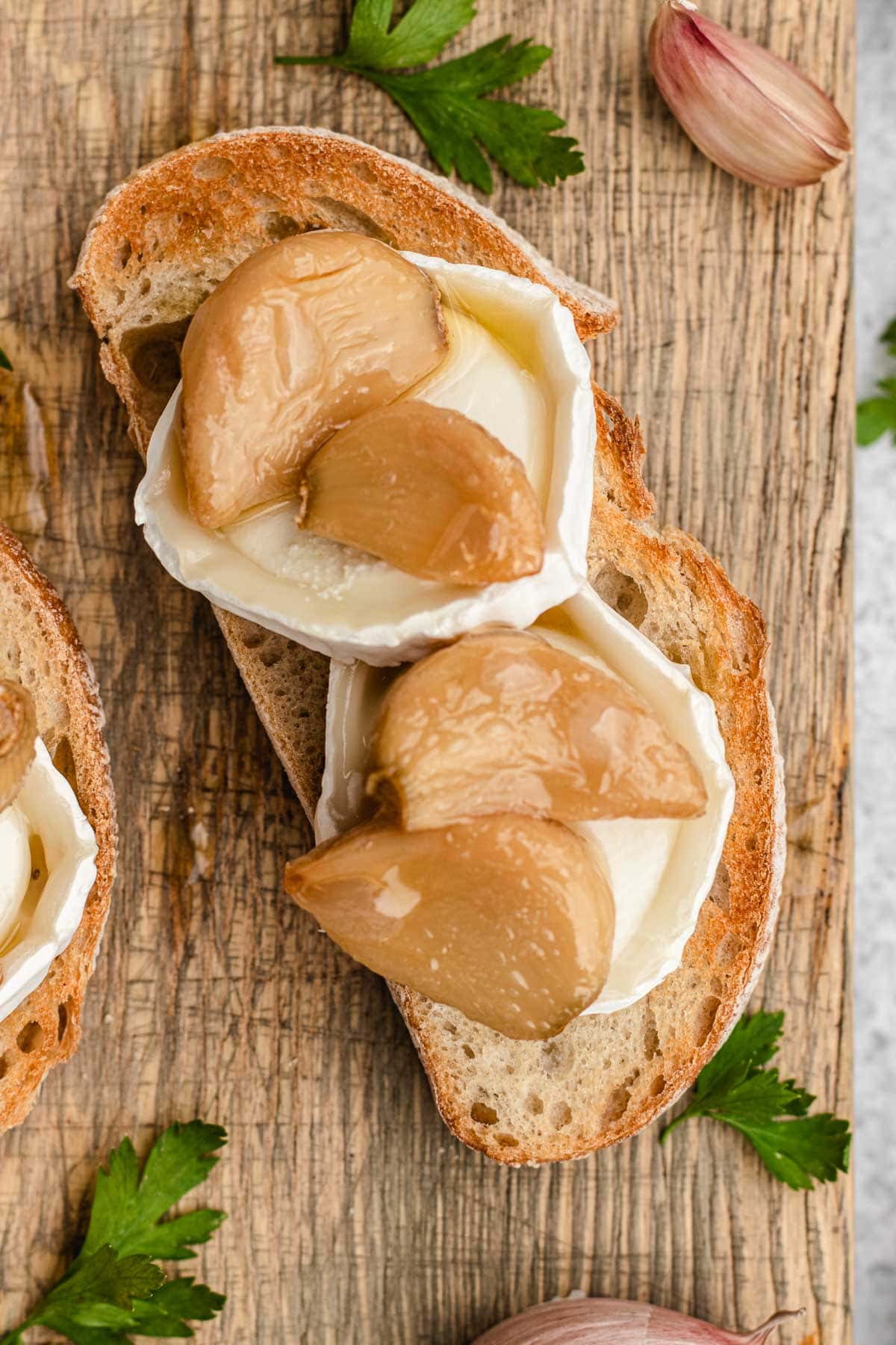 Garlic Confit roasted cloves on toast slice with goat cheese