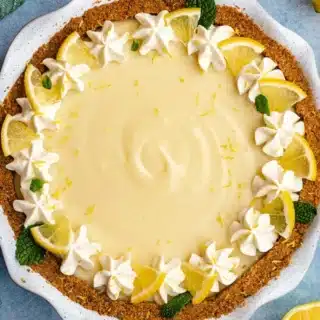 pie in pan decorated with whip cream and lemons