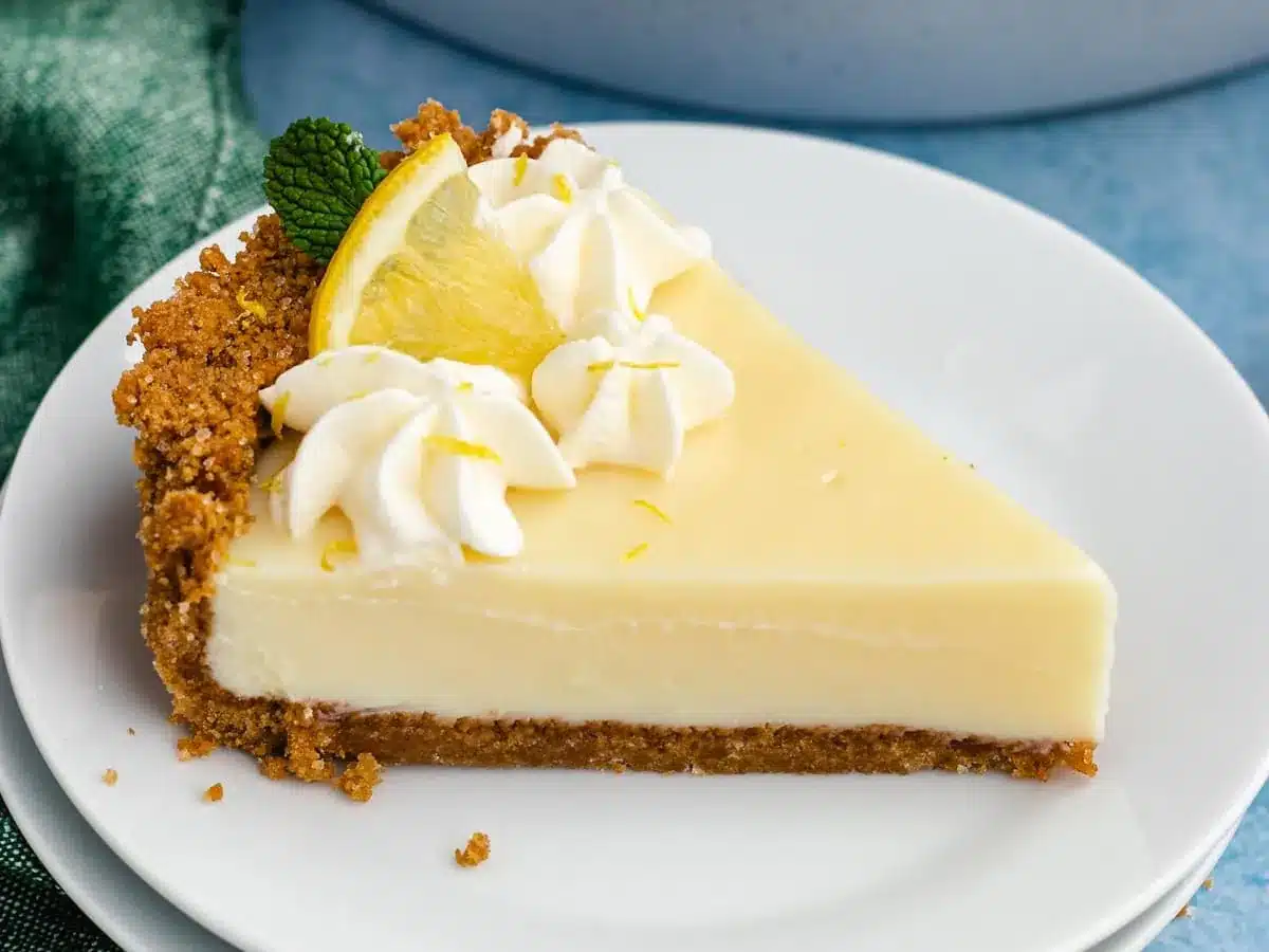 one slice of pie on plate decorated with whip cream and lemons