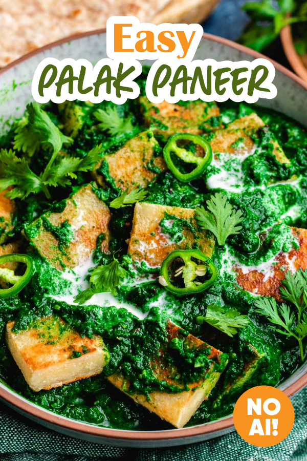 Large bowl with paneer cubes in a spinach gravy.