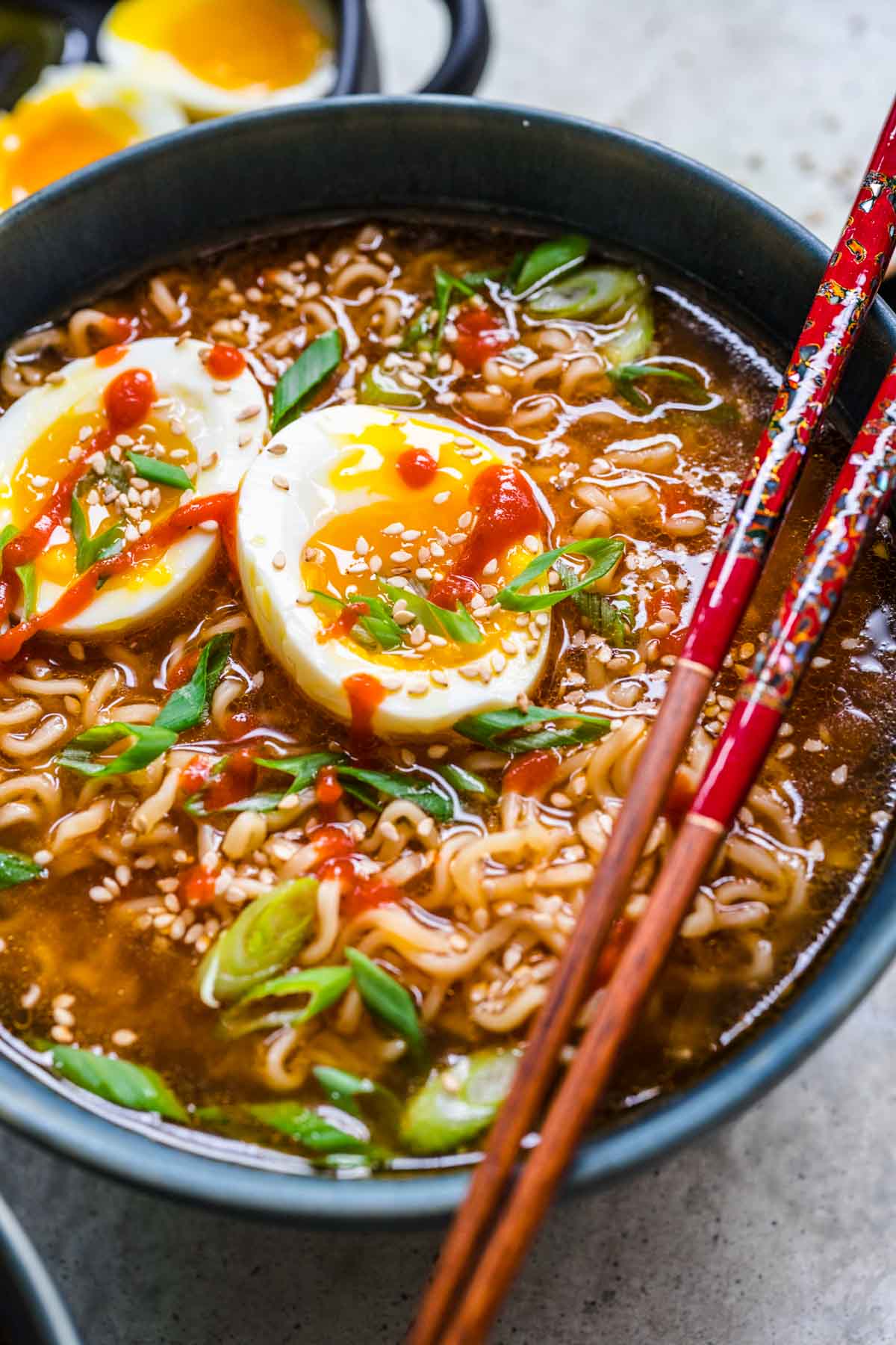 Spicy Ramen finished ramen with toppings in bowl and chopsticks resting on bowl