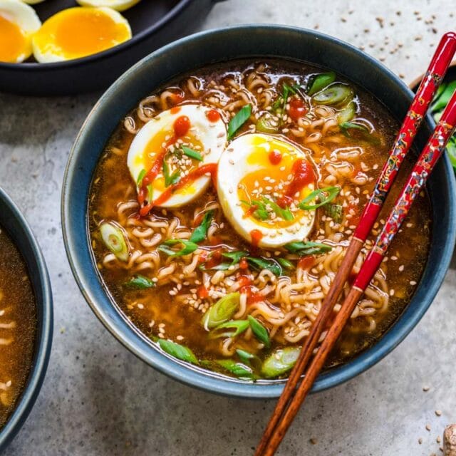 Finished ramen with toppings and chopsticks resting over bowl