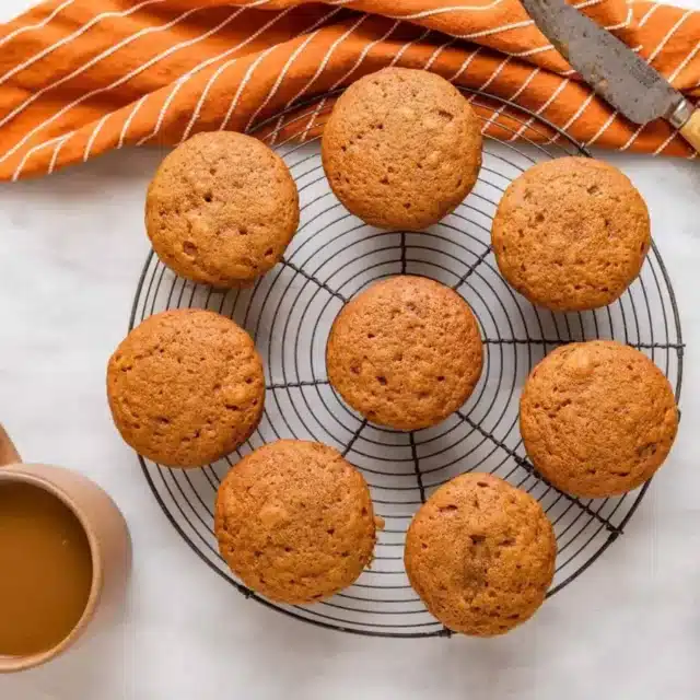 muffins on a wire rack with coffee on side