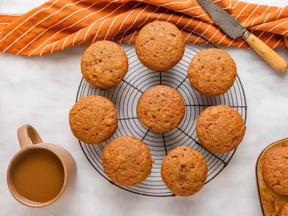 muffins on a wire rack with coffee on side