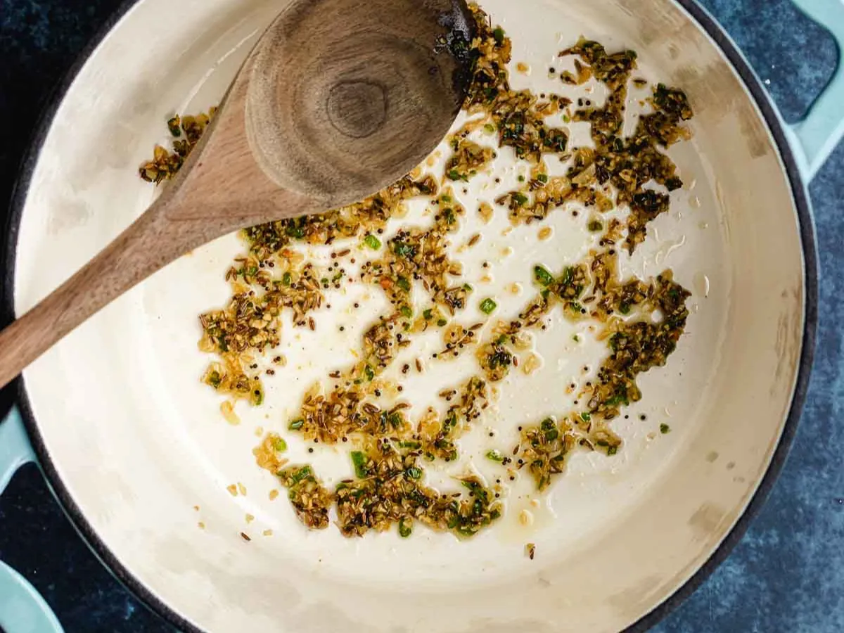 Spices and aromatics sautéing in pan.