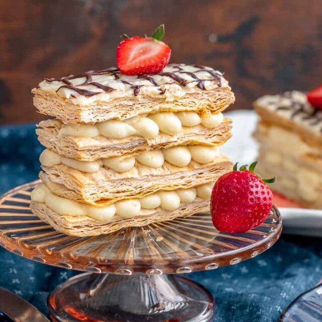 Layered French pastry on serving plate with strawberry garnish.