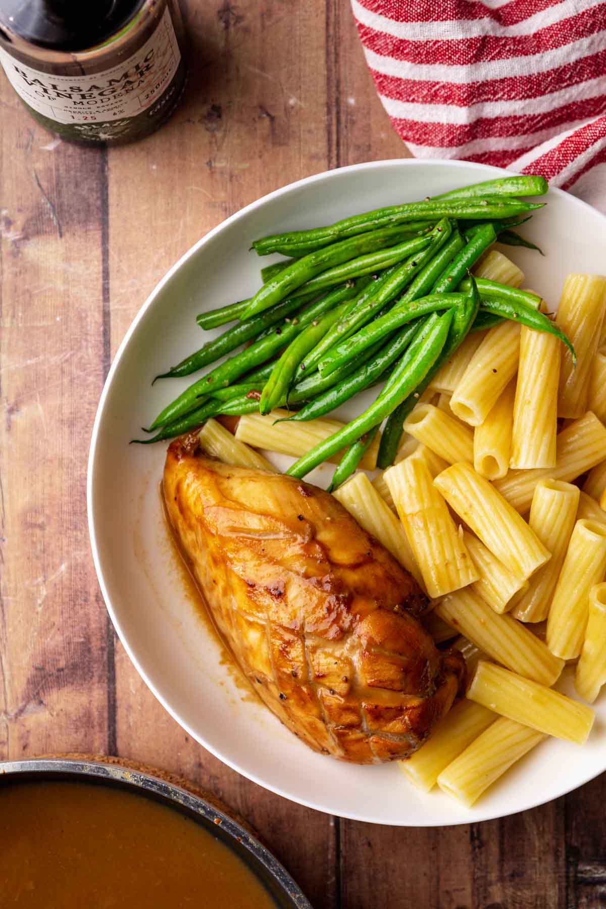 Balsamic Chicken baked chicken breast on plate with asparagus and pasta