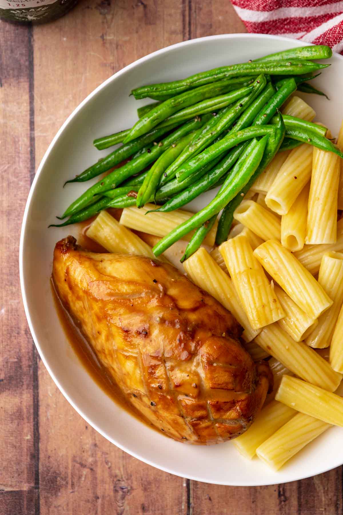Balsamic Chicken baked chicken breast on plate with asparagus and pasta