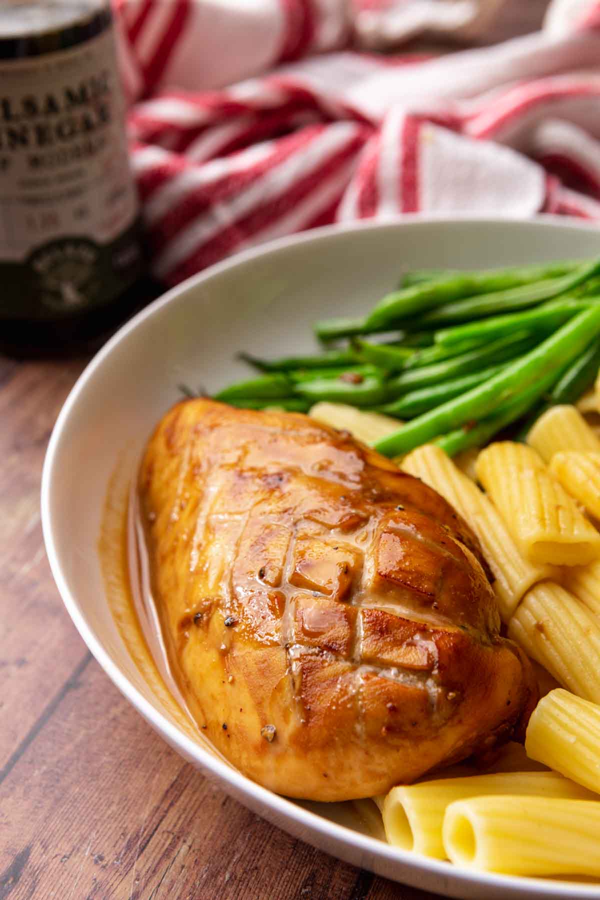 Balsamic Chicken baked chicken breast on plate with asparagus and pasta