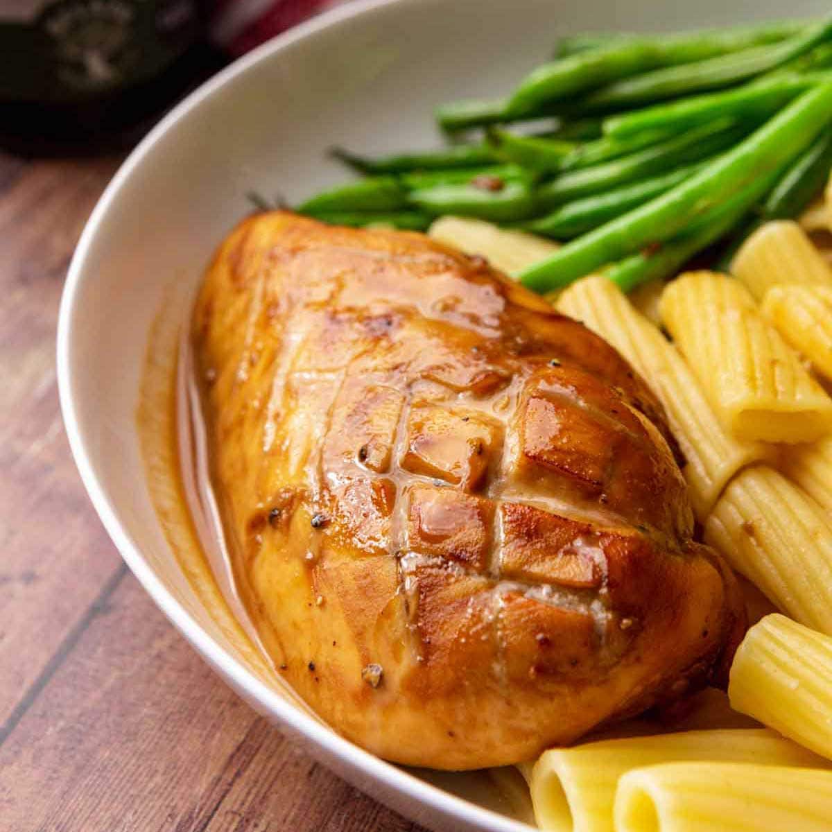 Balsamic Chicken baked chicken breast on plate with asparagus and pasta