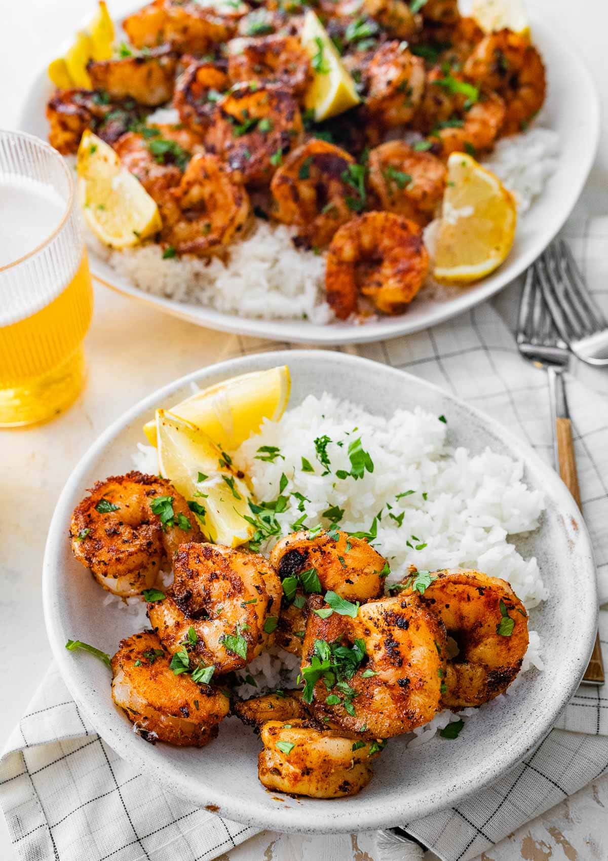 Cajun Shrimp cooked and garnished shrimp on plate with lemon wedges and rice