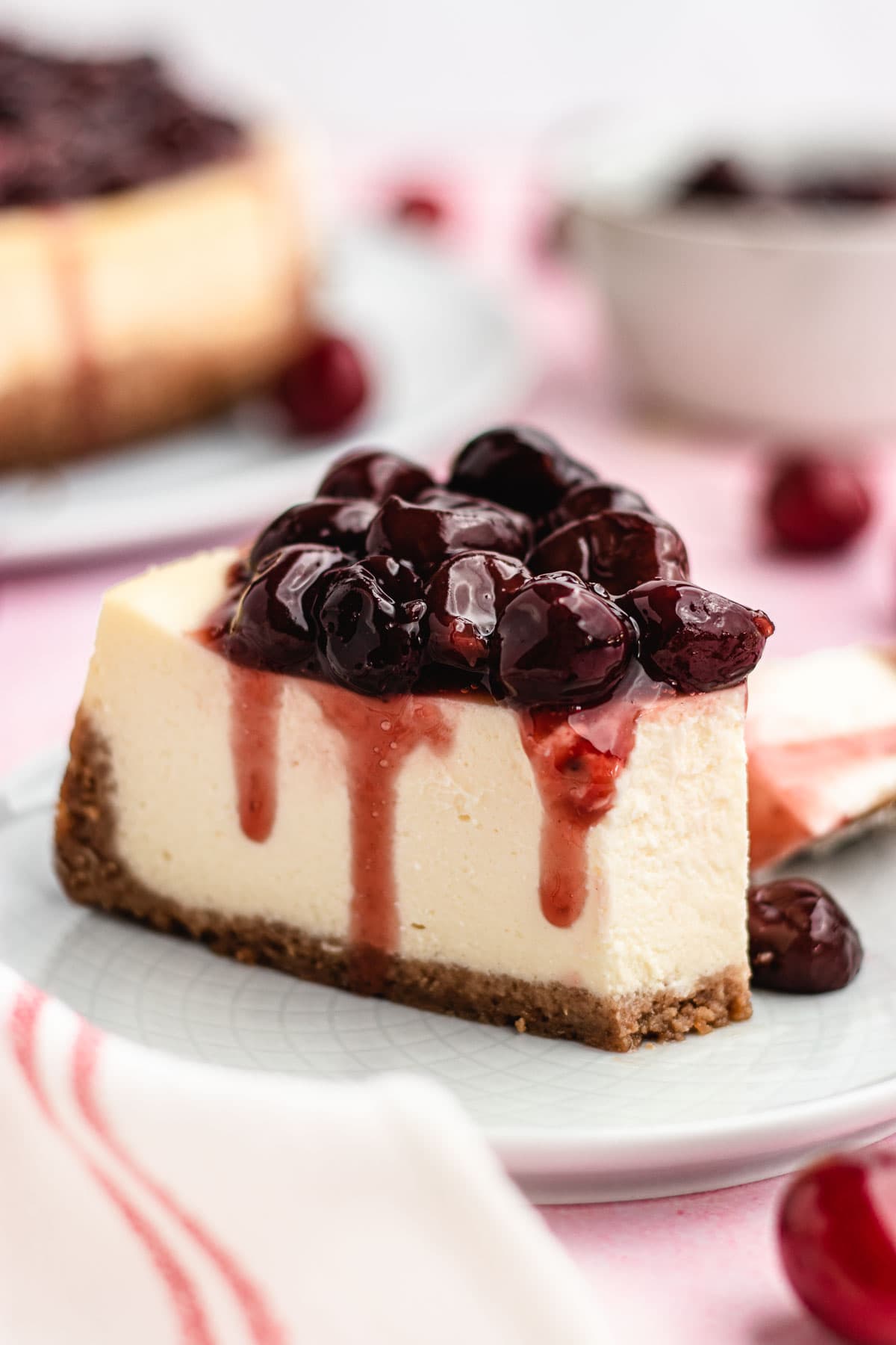 Cherry Cheesecake slice on plate with bite removed