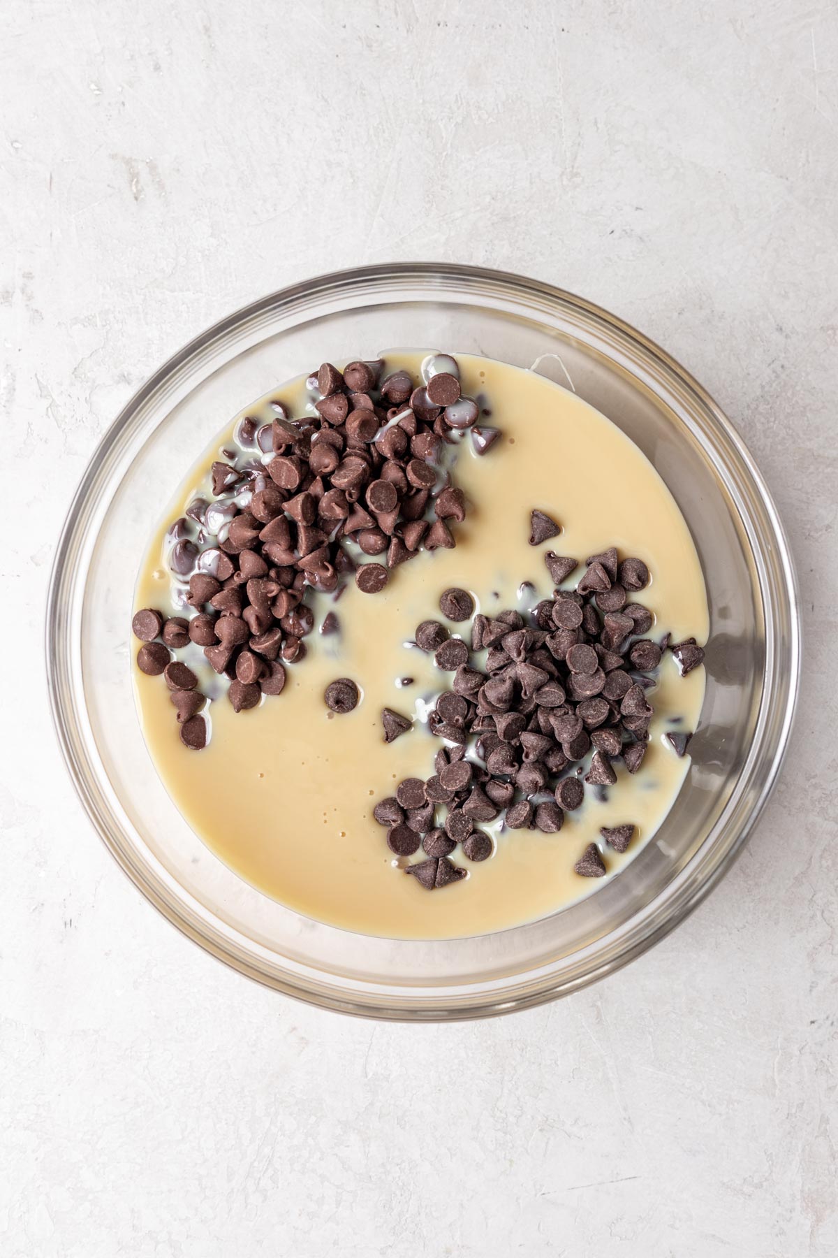 Chocolate Peppermint Fudge chocolate chips and condensed milk in glass mixing bowl before melting