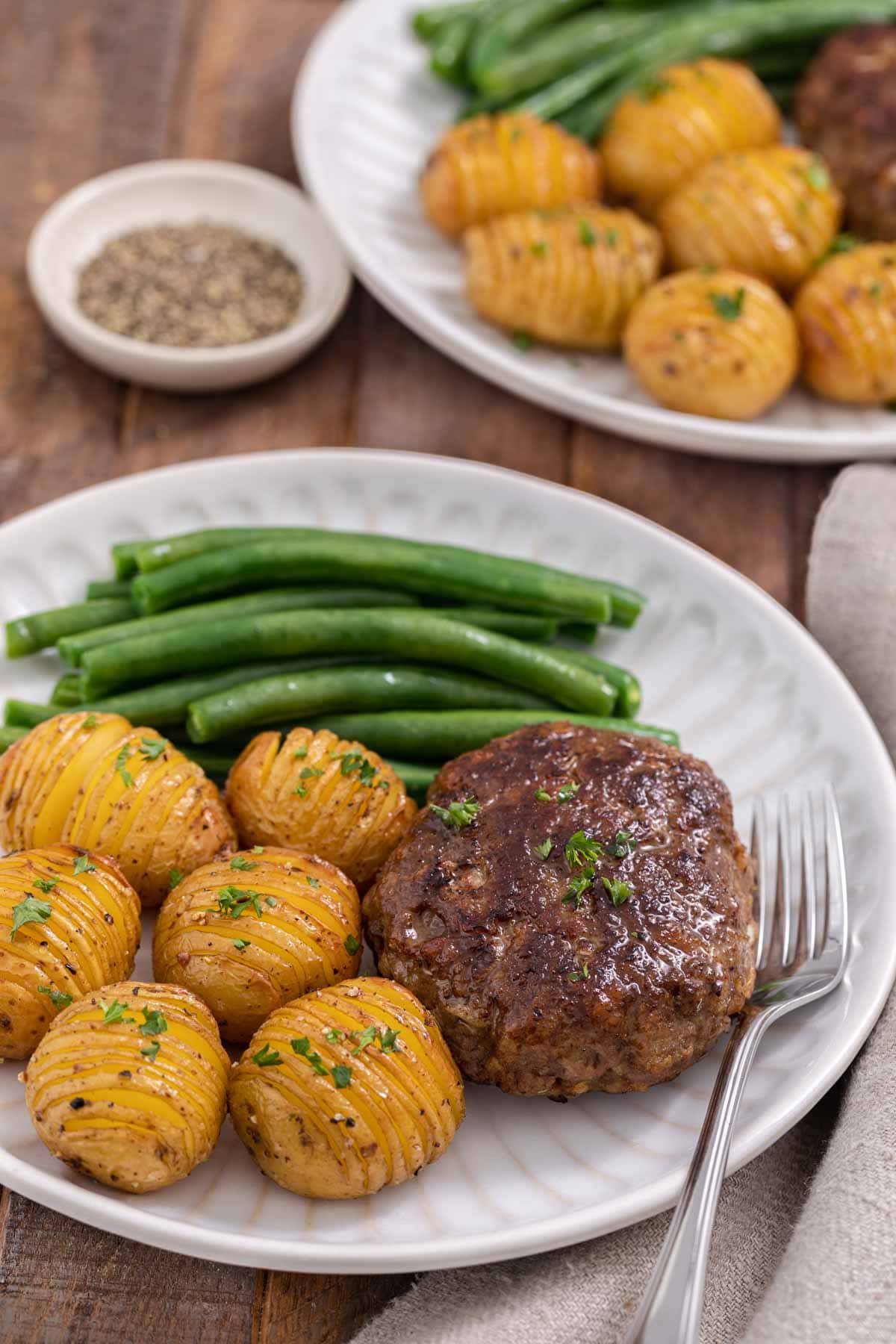 Chopped Steak cooked steak on plate with potatoes and green beans