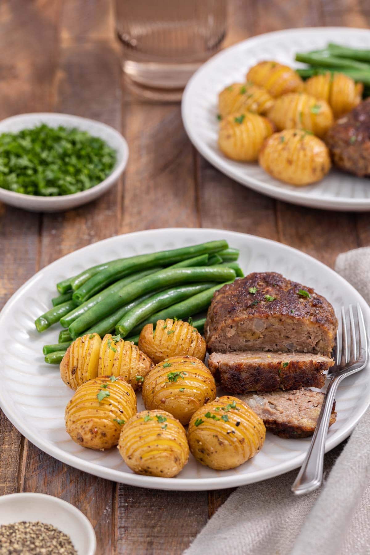 Chopped Steak cooked steak sliced on plate with potatoes and green beans