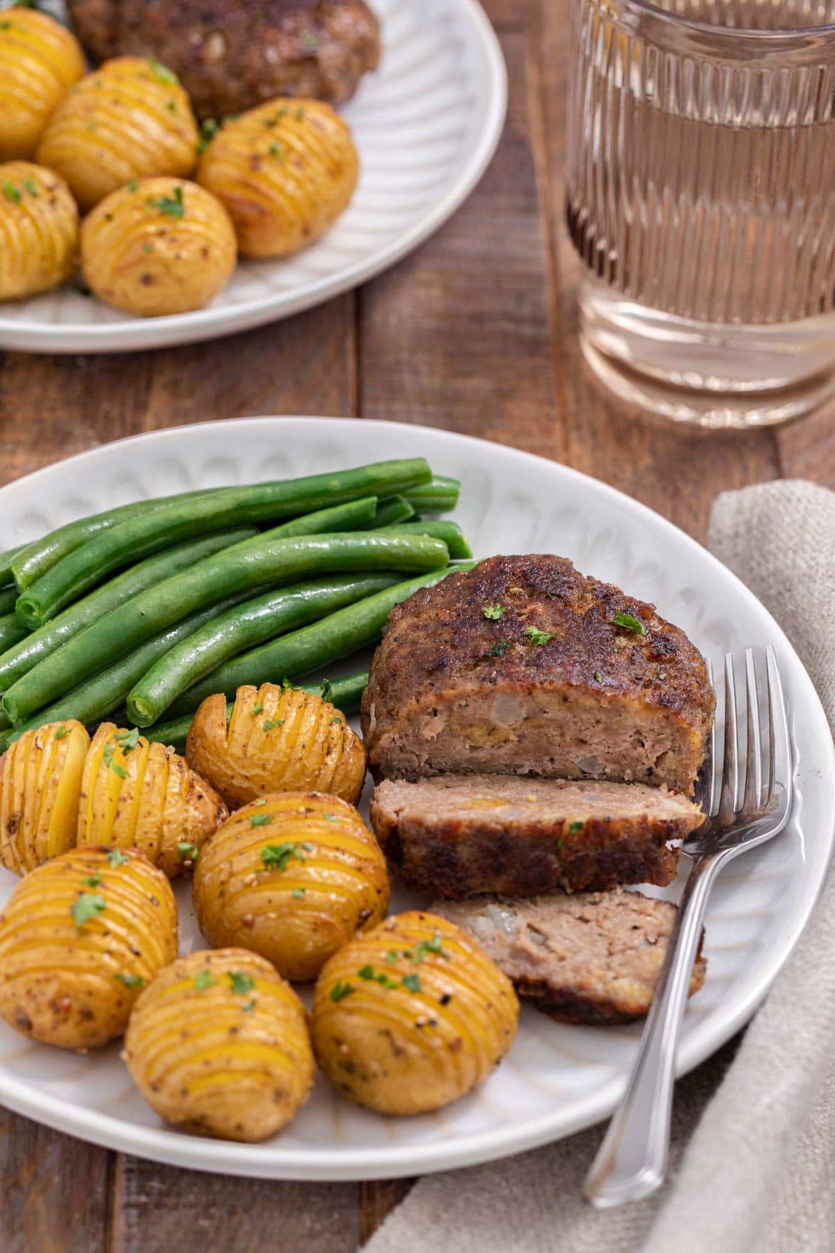 Chopped Steak cooked steak sliced on plate with potatoes and green beans