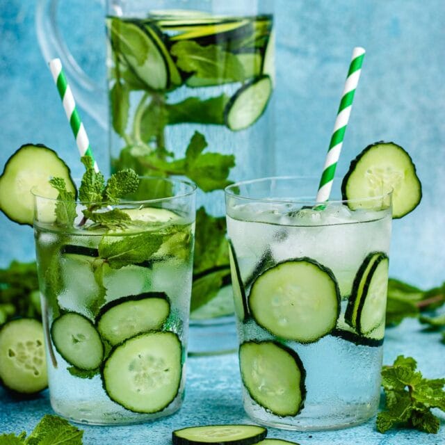 Cucumber Water in glasses with cucumber slices, with and without mint plus straws and ice