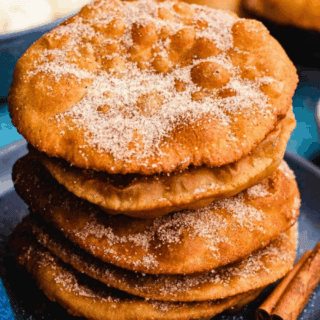 Bunuelos stacked on plate