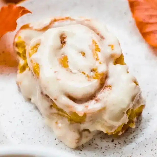 Roll with icing on plate