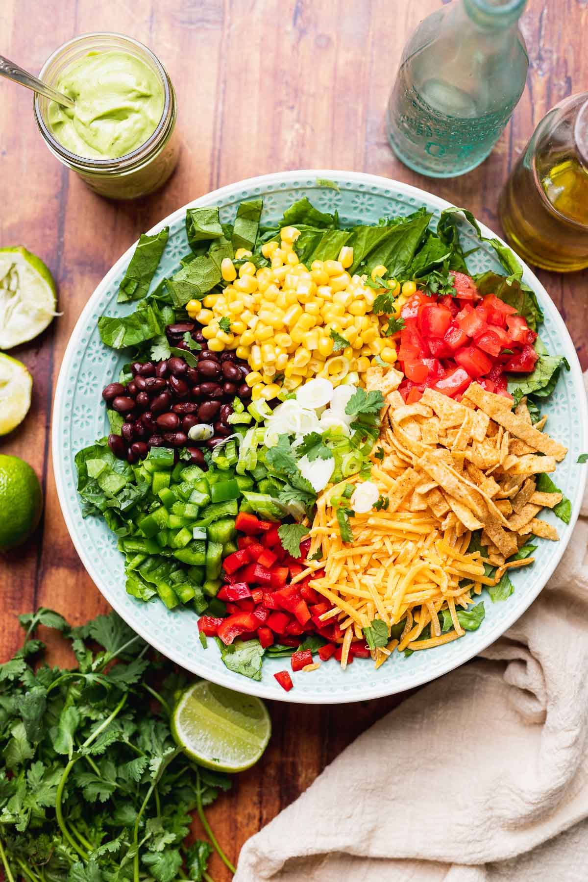 Southwest Salad all salad ingredients in bowl before tossing, dressing in jar off to side