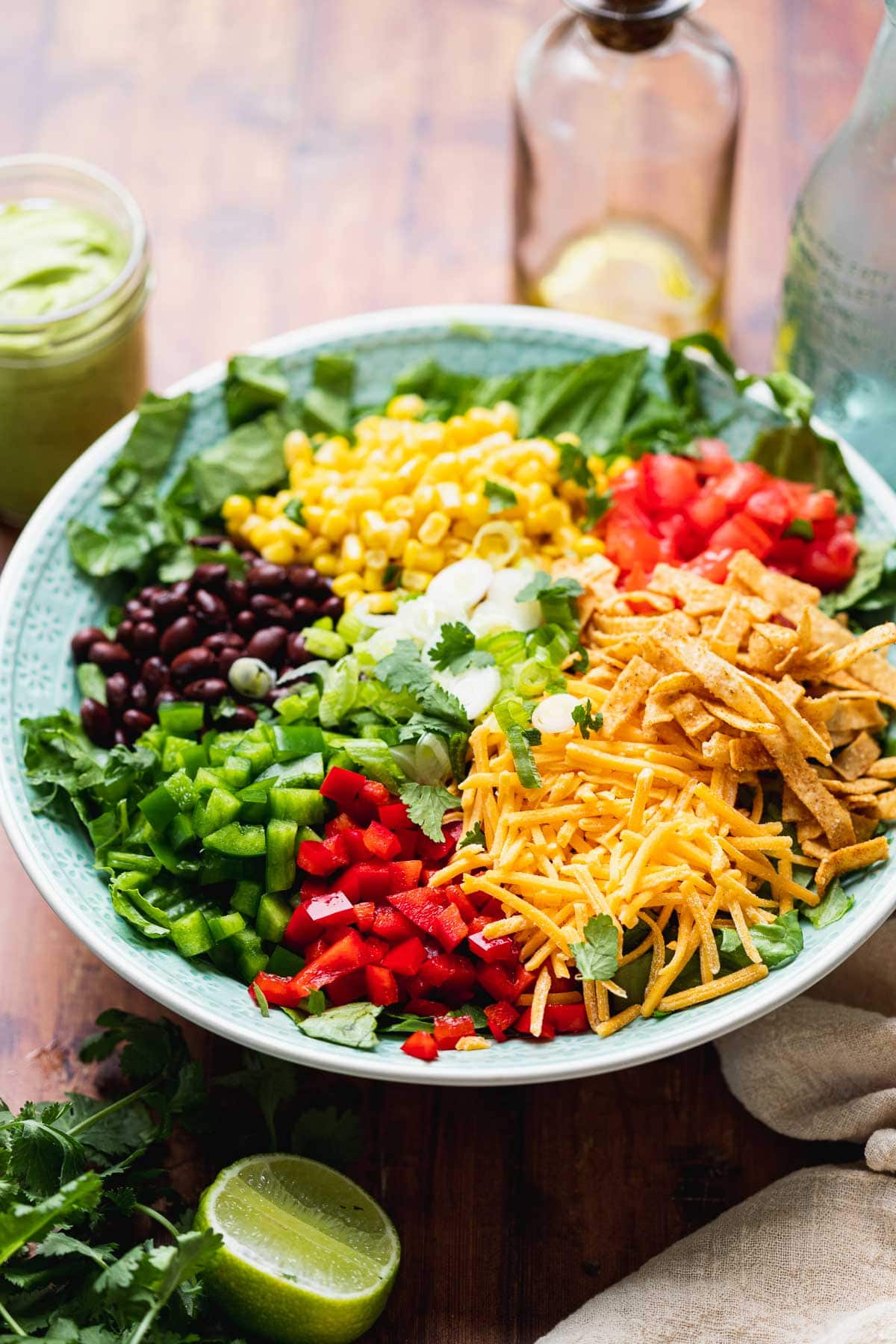 Southwest Salad all salad ingredients in bowl before tossing, dressing in jar off to side
