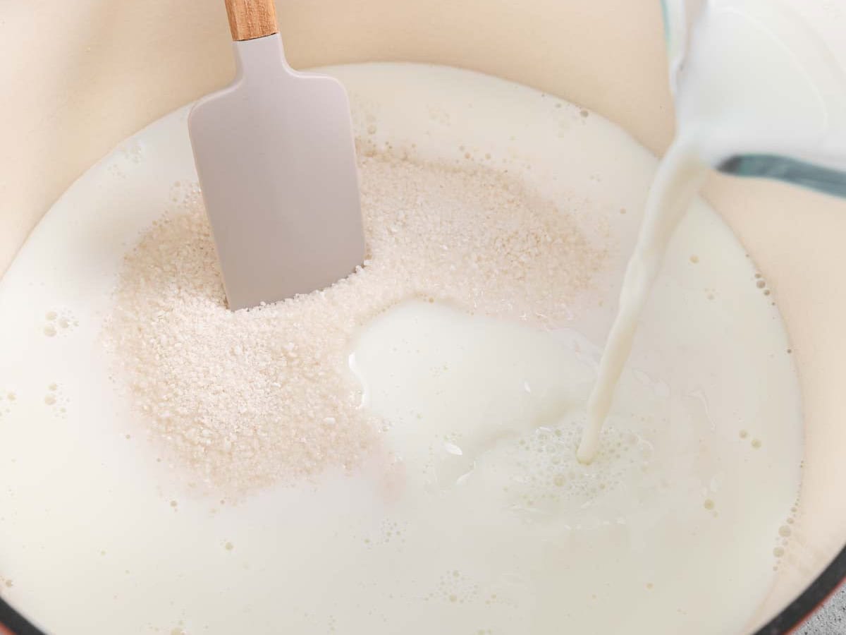 Stirring milk into pot