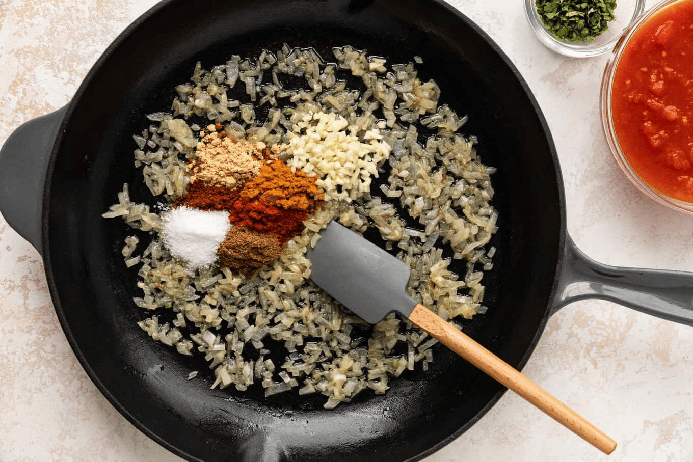 Onion, garlic, and spices in a skillet