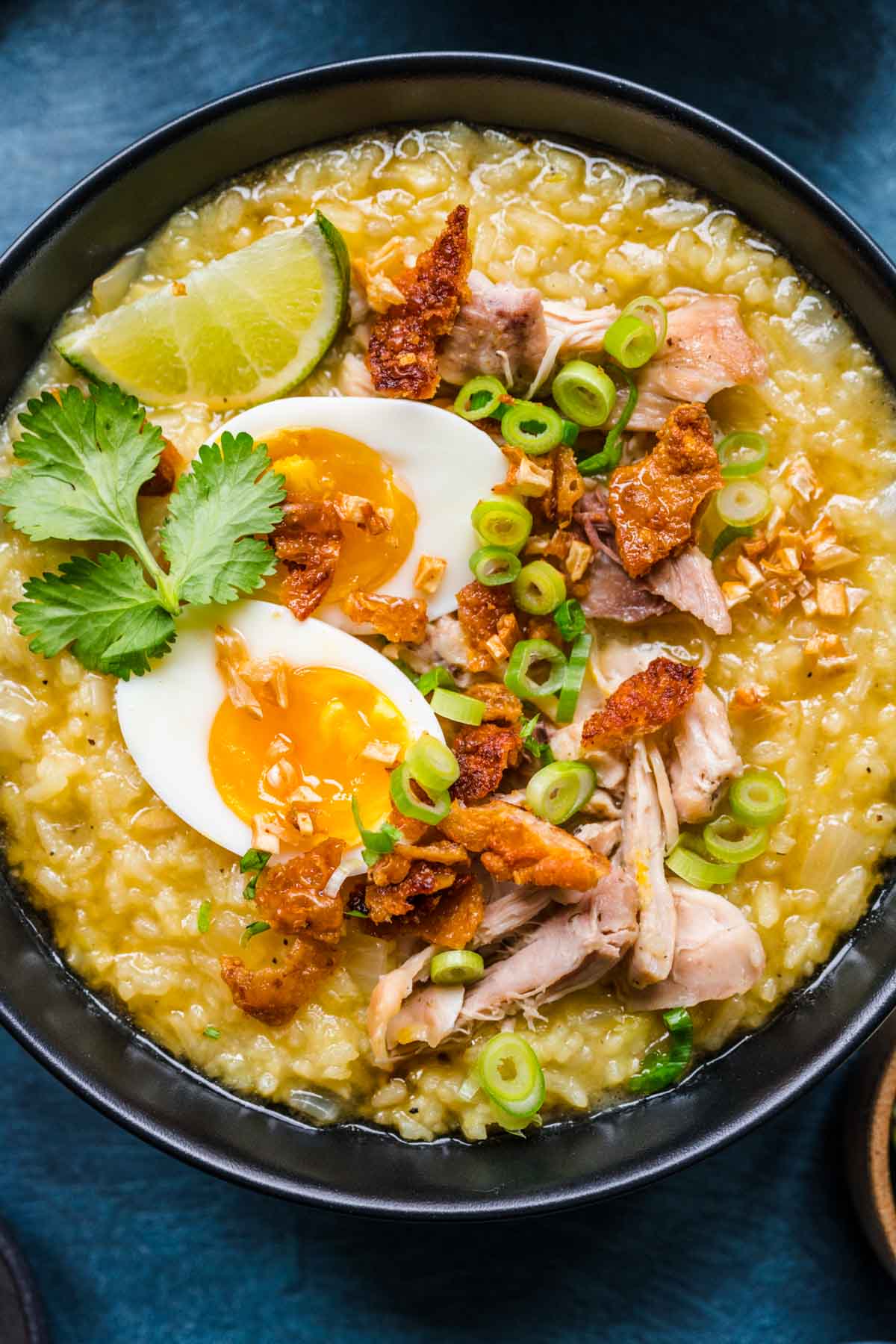 Arroz Caldo finished in bowl with toppings