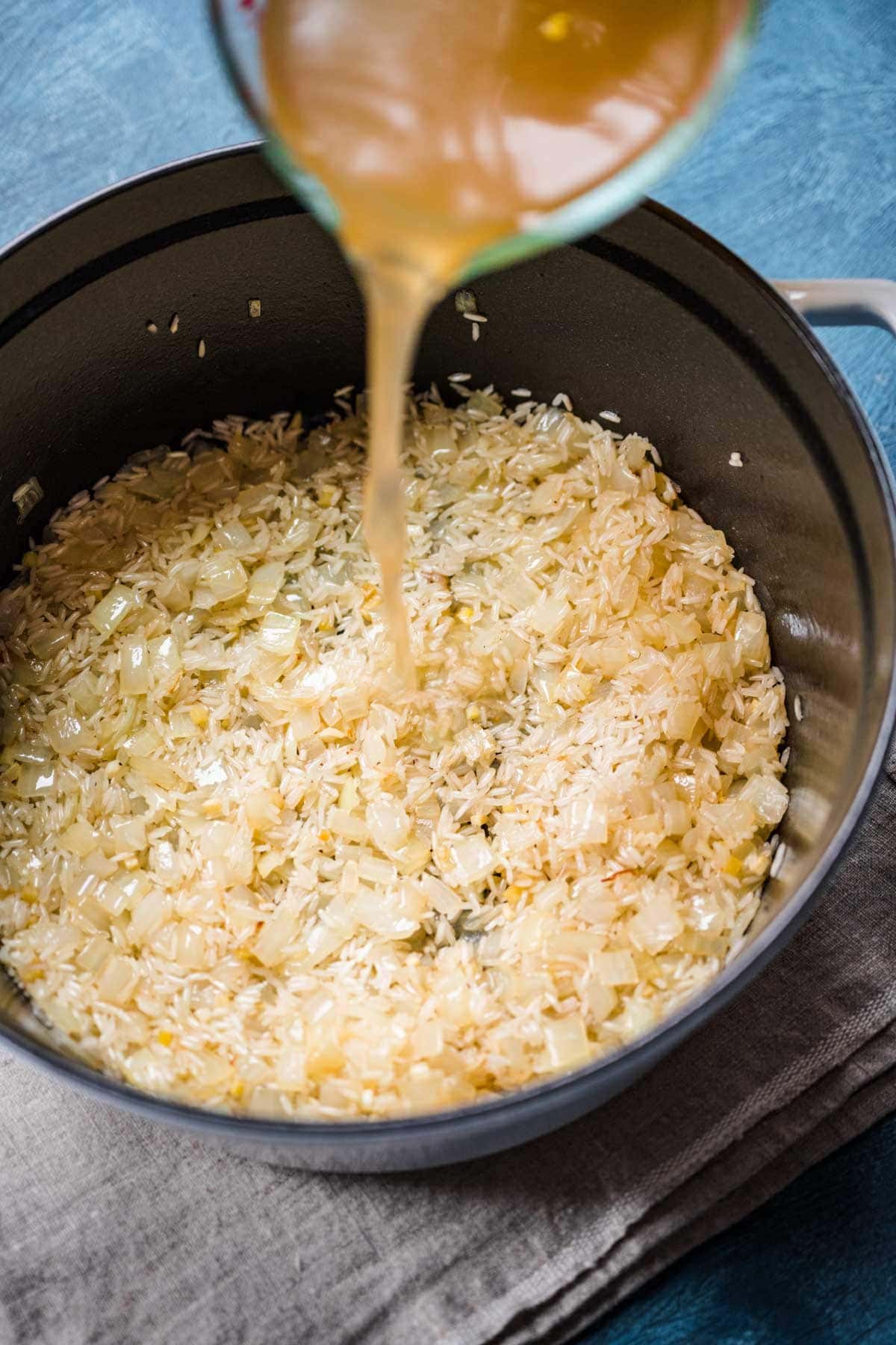 broth being added to rice 