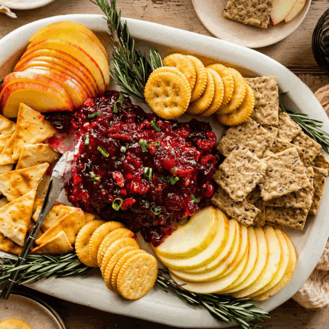 Dip on the center of a platter surrounded by various crackers